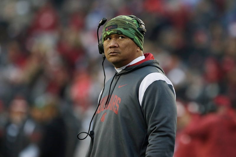 Washington State running backs coach Mark Atuaia stands on the field Mark Atuaia during a break in the game against Arizona State, Saturday, Nov. 12, 2022, in Pullman, Wash.