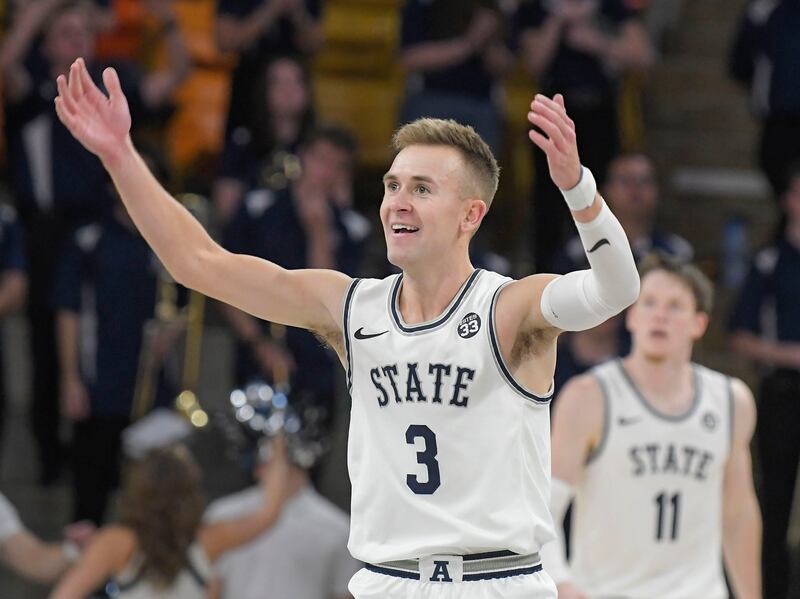 Utah State guard Steven Ashworth (wearing white) celebrates