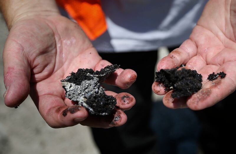 Donald Clark, chief geologist, breaks open some rock to show the oil content inside at the Petroteq Energy Inc. Asphalt Ridge mine and extraction plant outside of Vernal on Thursday, June 14, 2018.