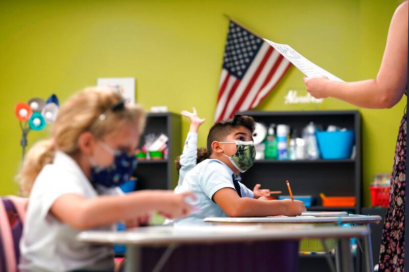 A student listens to the teacher’s instructions at iPrep Academy on the first day of school in Miami on Aug. 23, 2021.