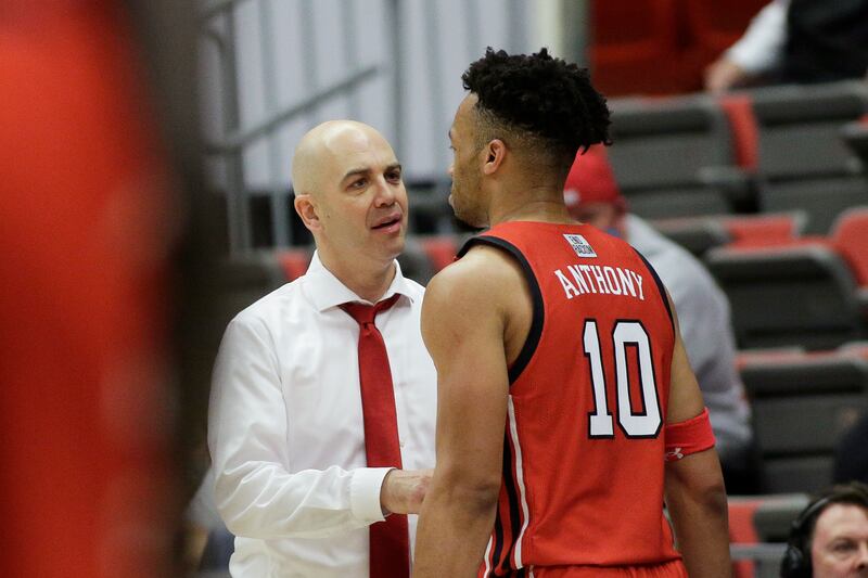 Utah head coach Craig Smith, left, speaks with guard Marco Anthony during game against Washington State, Jan. 26, 2022.