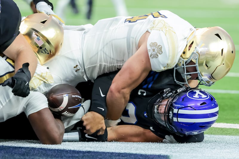 Notre Dame Fighting Irish linebacker Jack Kiser (24) takes down Brigham Young Cougars quarterback Jaren Hall (3) for a safety, giving the Irish a 12-6 lead, at Allegiant Stadium in Las Vegas on Saturday, Oct. 8, 2022.