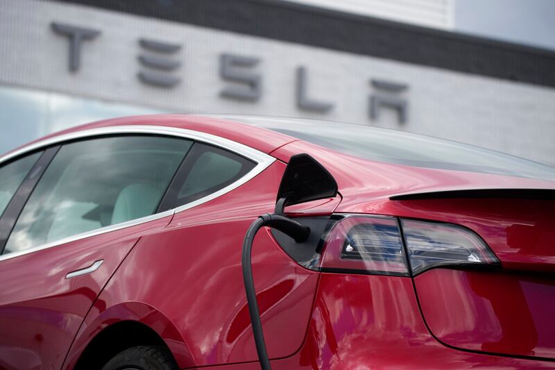 A 2021 Model 3 sedan charges at a Tesla dealership in Littleton, Colo., on June 27, 2021.