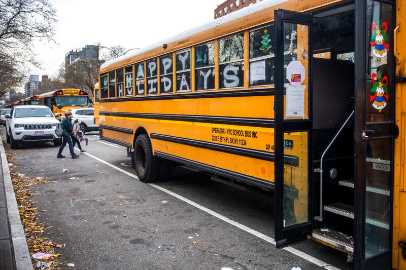 Students wear masks while leaving the Nest school on Tuesday, Dec. 21, 2021, in New York.