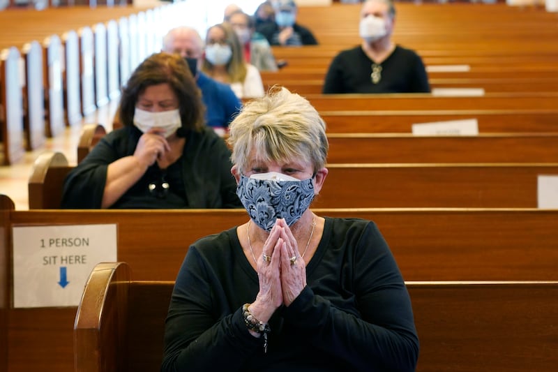 Diane Leahy prays with others before receiving a COVID-19 vaccine at St. Patrick Catholic Church in Miami Beach, Florida. A coronavirus variant originally discovered in Colombia has made its way to South Florida, and health officials expressed concern about what it means for unvaccinated people, according to The Washington Post.