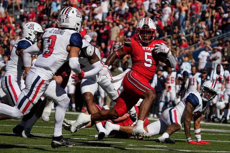 Utah running back TJ Pledger (5) in the first half during a game against Arizona.