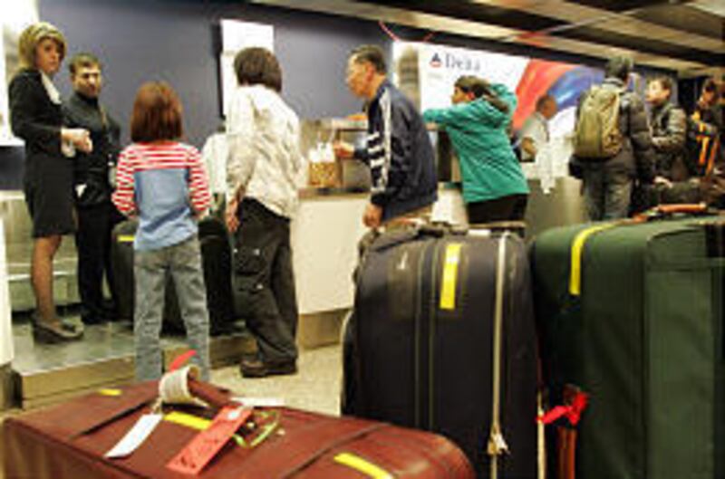 Travelers line up at Delta Air Lines ticket counters at Salt Lake International Airport.