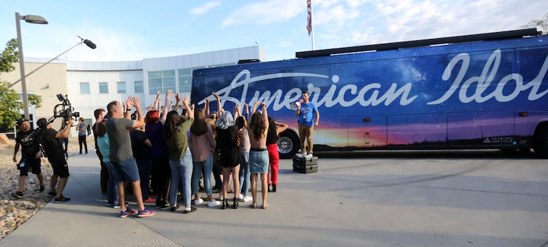 Production assistant Collin DeClerk tries to get the crowd excited while filming before “American Idol” auditions in Salt Lake City.
