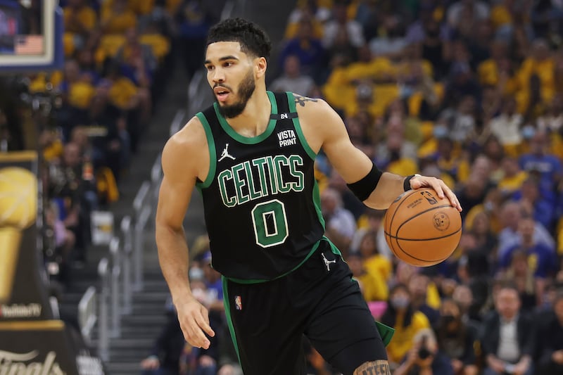 Boston Celtics forward Jayson Tatum brings the ball up the court against the Golden State Warriors during Game 5 of the NBA Finals.