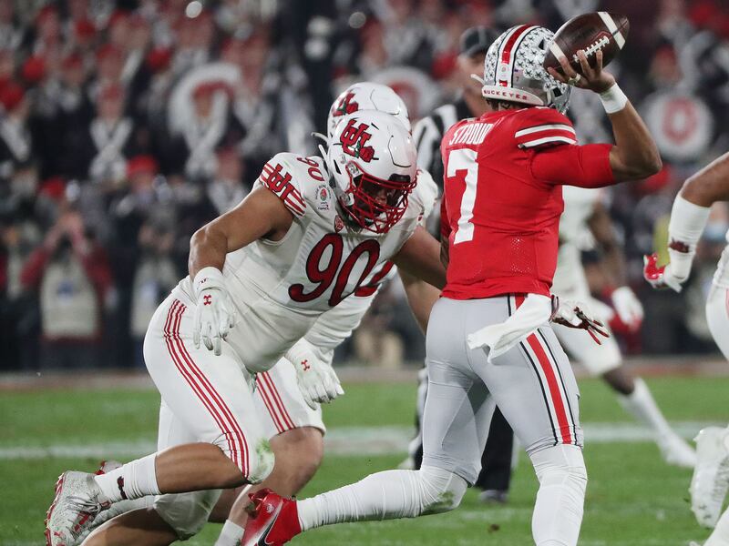 Utah defensive tackle Devin Kaufusi pressures Ohio State quarterback C.J. Stroud during the Rose Bowl in Pasadena, Calif.