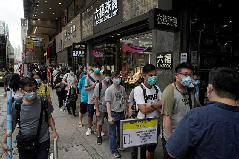 Gaming enthusiasts queue up for the pre-order sales of the newly unveiled Japanese brand video game console, Sony’s PlayStation 5 (PS5), outside a retailer in Hong Kong, Friday, Sept. 18, 2020. Pre-orders of PlayStation 5 started on Sept. 17 and will be filled on Nov. 19.
