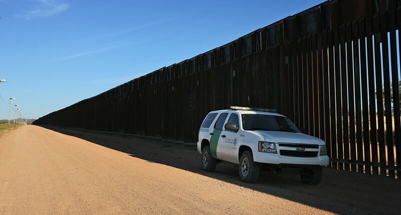 A U.S. Border Patrol agent monitors the border fence between Douglas, Ariz., and Agua Prieta, Sonora, Mexico.