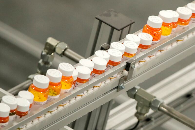 Bottles of medicine ride on a belt at a mail-in pharmacy warehouse in Florence, N.J.