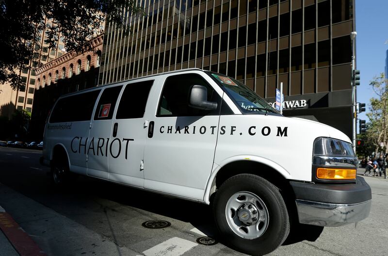 In this April 14, 2015, photo, a Chariot shuttle bus drives in San Francisco. A company called Leap, a bus company that offers rides with spacious seating, free Wi-Fi and attendants who deliver snacks, launched the service last month with morning and even