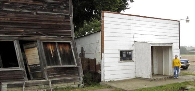 Elsie Eiler stands near the bar and grill she owns in Monowi, Neb. Eiler is Monowi's entire population.