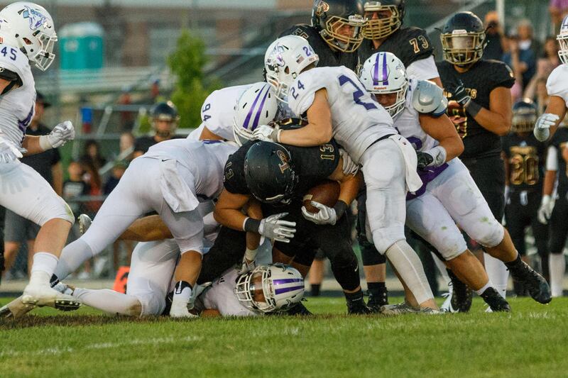 Lehi defenders pile onto Masen Wake (13). Lone Peak vs Lehi (40-7), September 1, 2017.