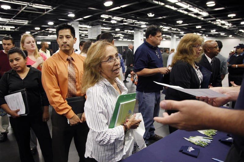 In this June 13, 2012 file photo, Maria Wilt, center, talks to a recruiter at a job fair expo in Anaheim, Calif.