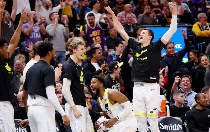 Utah Jazz players celebrate with the crowd after two consecutive missed Clipper free throws give free Chick-fil-A.