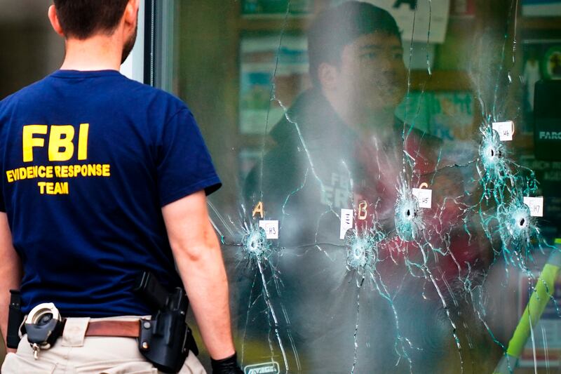 Investigators work the scene of a shooting at a supermarket, in Buffalo, N.Y., Monday, May 16, 2022.