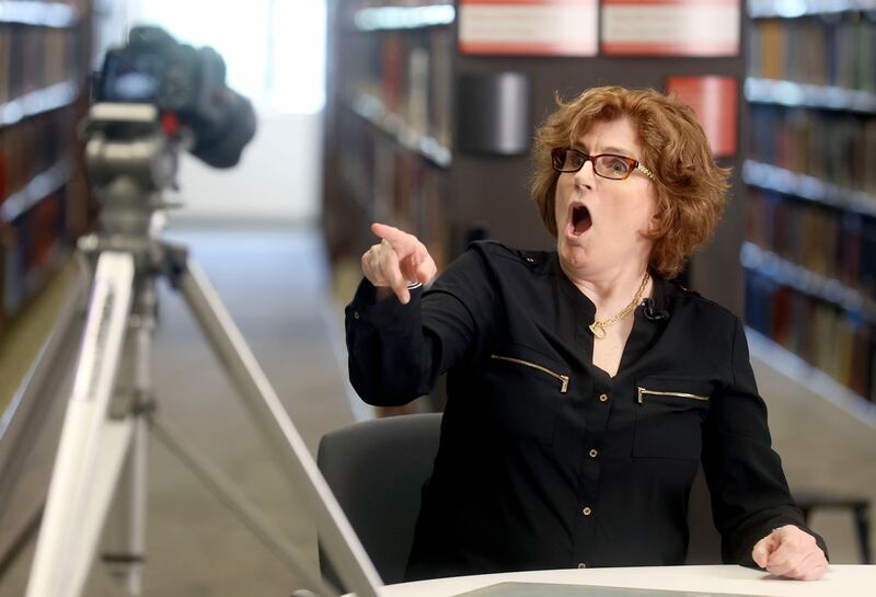 Photographer Kimberly Butler reacts to learning that she is related to others in the room while filming a documentary about her life.
