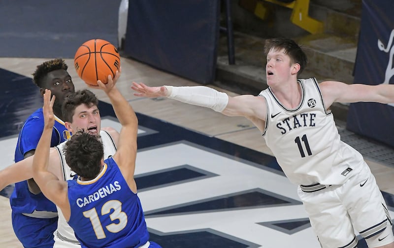 San Jose State guard Alvaro Cardenas (13) shoots as Utah State guard Max Shulga (11) defends during the first half of an NCAA college basketball game Saturday, Jan. 21, 2023, in Logan, Utah. (Eli Lucero/The Herald Journal via AP)