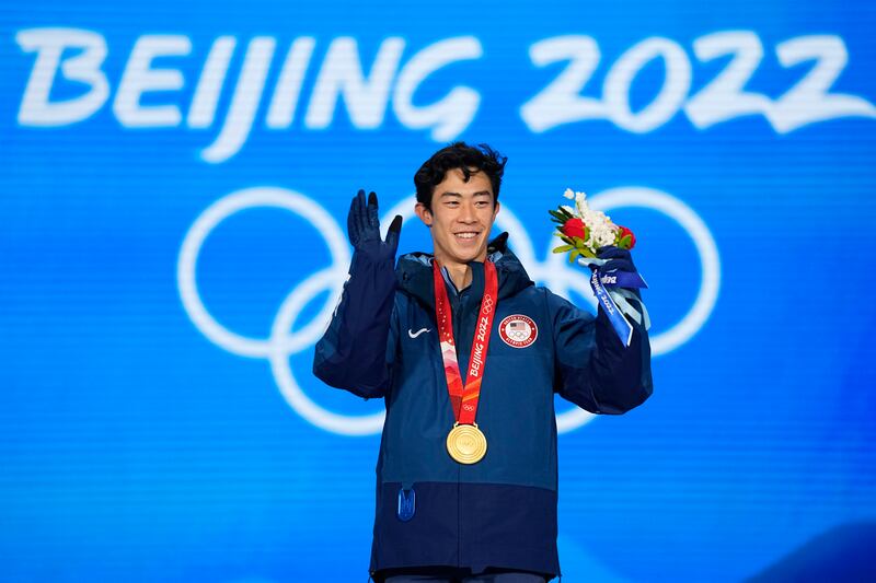 Gold medalist Nathan Chen of the U.S. celebrates during the medal ceremony for the men’s free skate at the 2022 Winter Olympics, Feb. 10, 2022.