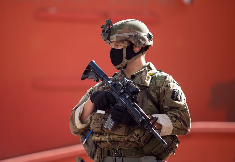 Members of California National Guard patrol, Sunday, May 31, 2020, in Los Angeles. The National Guard is patrolling Los Angeles as the city begins cleaning up after a night of violence by demonstrators that saw clash with officers and torch police vehicles and pillage stores. (AP Photo/Ringo H.W. Chiu)