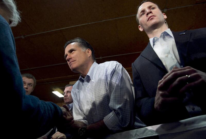 Republican presidential candidate, former Massachusetts Gov. Mitt Romney greets people in the crowd as a Secret Service agent watches at right during a campaign stop at a building supply store in Green Bay, Wis., Monday, April 2, 2012.