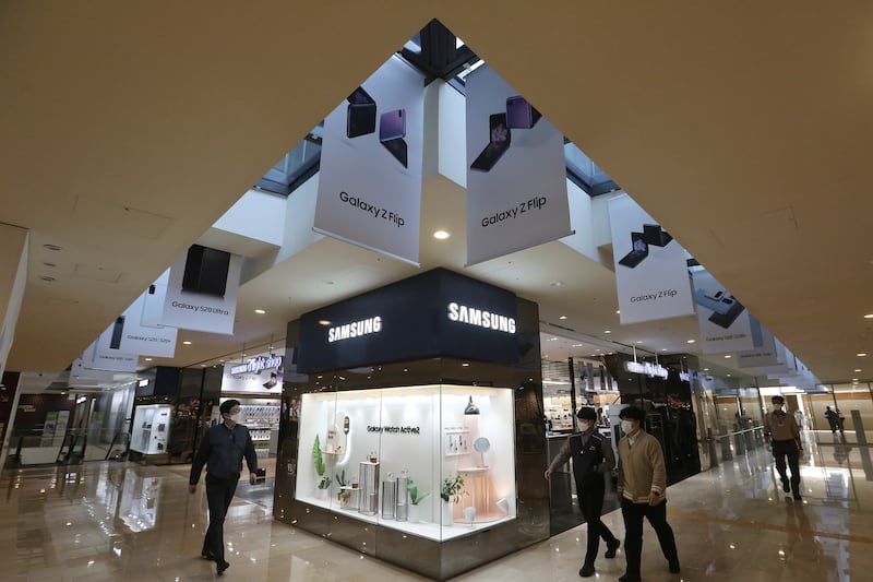 People walk under advertisements for Samsung Electronics’ Galaxy S20 Ultra and Galaxy Z Flip smartphone in Seoul, South Korea.