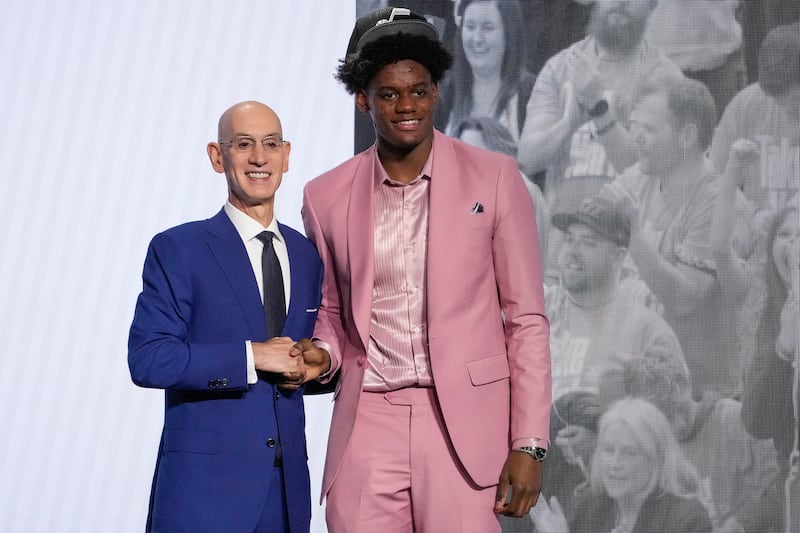 Taylor Hendricks poses for a photo with NBA Commissioner Adam Silver after being selected ninth overall by the Utah Jazz During the NBA basketball draft, Thursday, June 22, 2023, in New York. (AP Photo/John Minchillo)