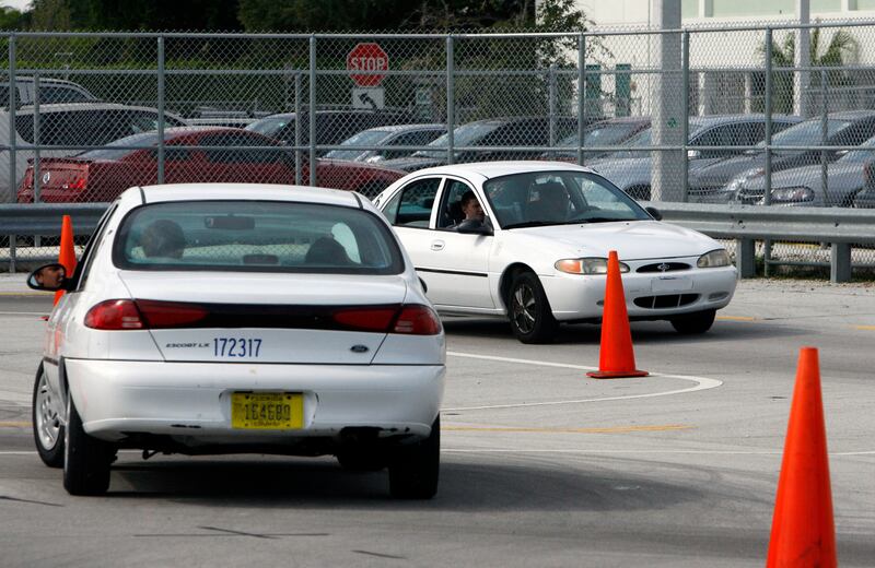 Driver’s ed students drive a course at Miami Killian Senior High School in Miami.