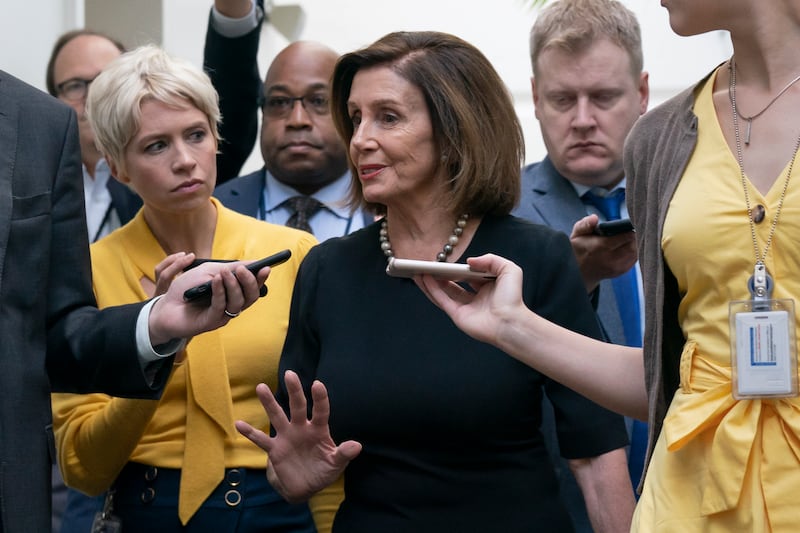 Speaker of the House Nancy Pelosi, D-Calif., is surrounded by reporters as she arrives to meet with her caucus the morning after declaring she will launch a formal impeachment inquiry against President Donald Trump, at the Capitol.