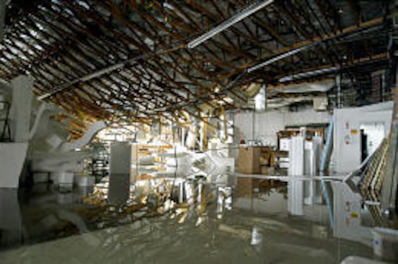 Water covers the floor of Scenic Design in Murray after three-quarters of the roof collapsed. The business is expected to be closed for a month.