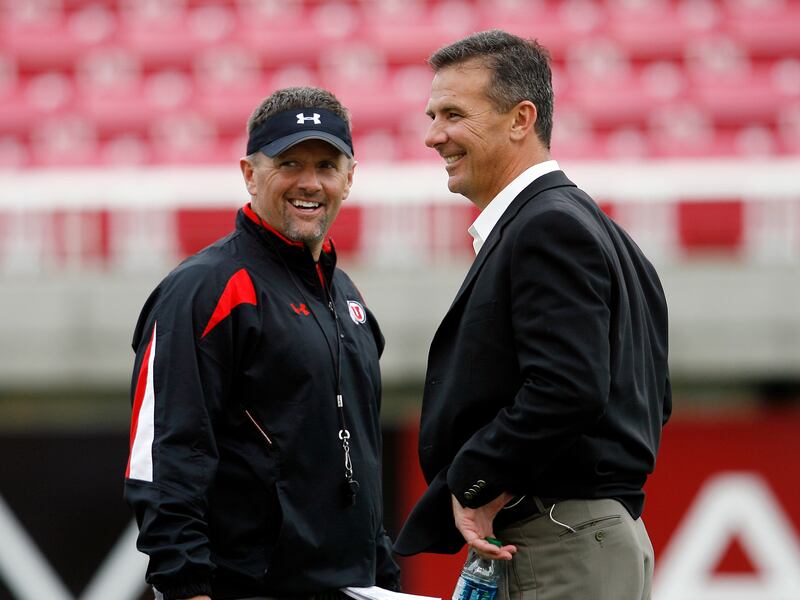Former Utah coach Urban Meyer, right, talks with Utah coach Kyle Whittingham during a Utah practice at Rice-Eccles Stadium.