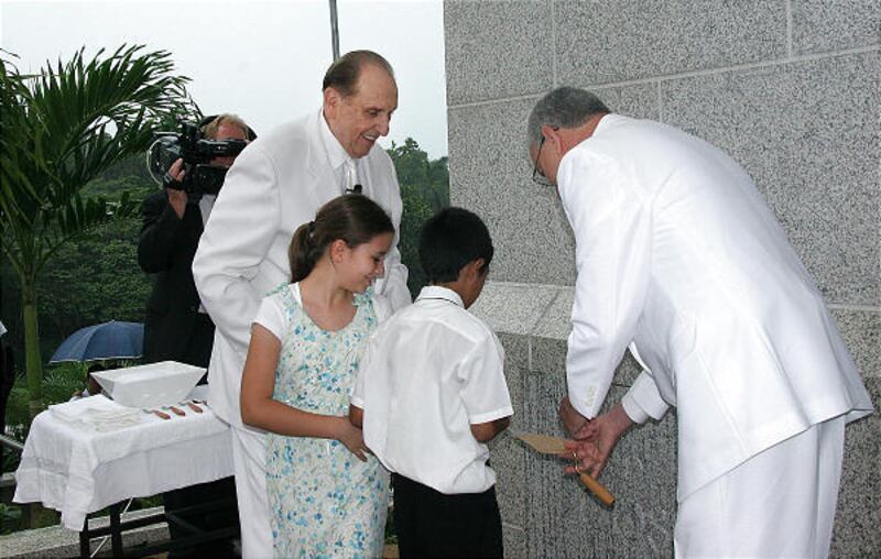 LDS Church President Thomas S. Monson, left, is joined by children Brenda Vantonder and Eynar Pitty during the cornerstone ceremony at the Panama City, Panama Temple Sunday.