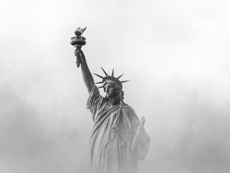 The Statue of Liberty set against fog in New York City.