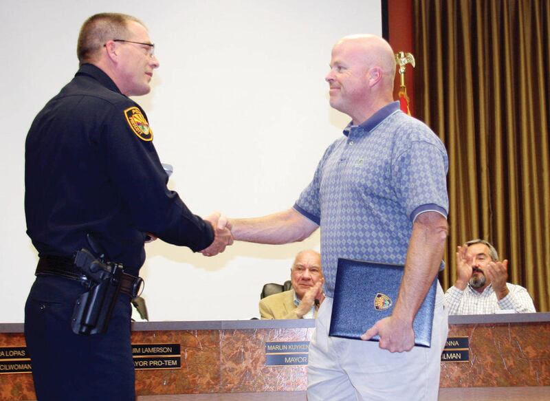 Prescott resident Keith Beesmer, right, receives a civilian commendation from Prescott Police Chief Mike Kabbel in this April 2011 photo for returning a lost class ring after 27 years of looking for the owner.