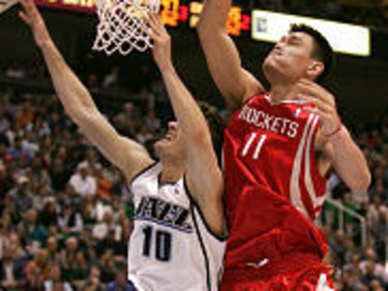 Houston's Yao Ming swats away the shot of Utah's Gordan Giricek.