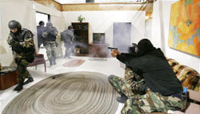 Ogden SWAT team members train Tuesday at the center, which features 16 cameras to capture the action and allow critiques of the maneuvers.