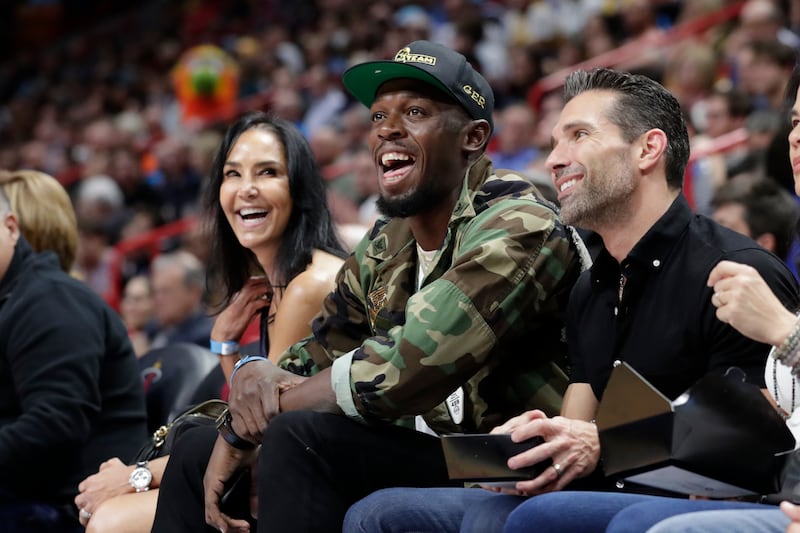 Usain Bolt watches during the first half of an NBA basketball game between the Miami Heat and Los Angeles Lakers, Friday, Dec. 13, 2019, in Miami.
