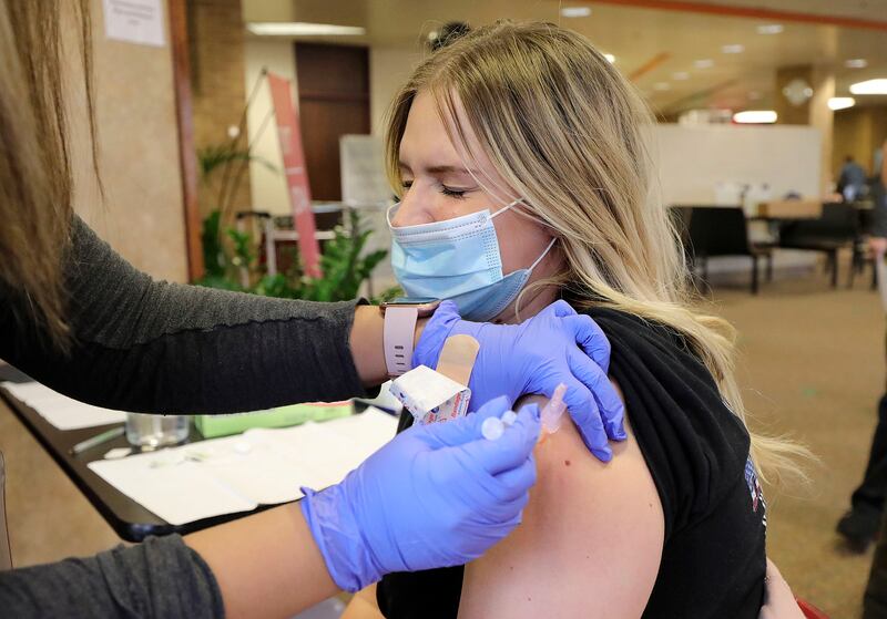 McKinnah Anderson, Gold Cross Ambulance paramedic, gets the Moderna COVID-19 vaccine.