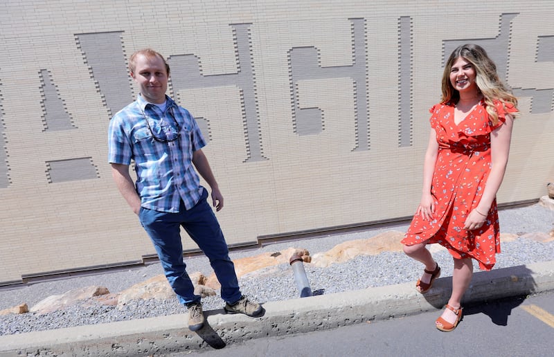 Nate Larsen and Morgan Erickson, graduates from Utah State University's new outdoor product design and development program, pose for a photo after graduation at the Dee Glen Smith Spectrum in Logan on Thursday, May 2, 2019.