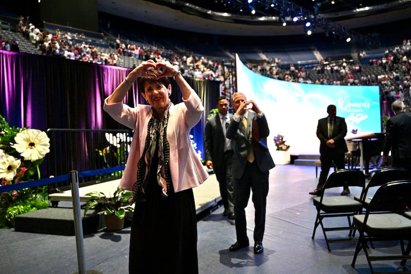 Sister Susan Bednar, left, and Elder David A. Bednar, right, make a heart sign to attendees of BYU Women's Conference, in the Marriott Center in Provo, Utah, on Friday, May 1, 2026.
