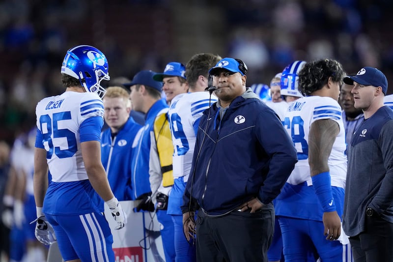 BYU coach Kalani Sitake, middle, watches during the first half of the team’s NCAA college football game against Stanford in Stanford, Calif., Saturday, Nov. 26, 2022.