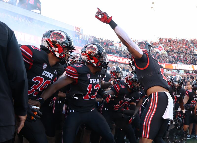 Utah players run onto the field ahead of game against USC at Rice-Eccles Stadium in Salt Lake City on Saturday, Oct. 15, 2022.