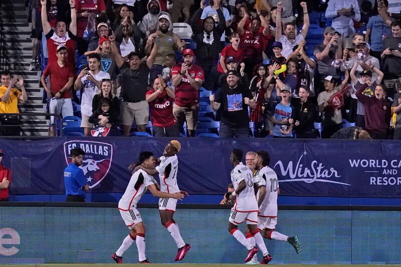 Fans cheer as FC Dallas forward Bernard Kamungo celebrates