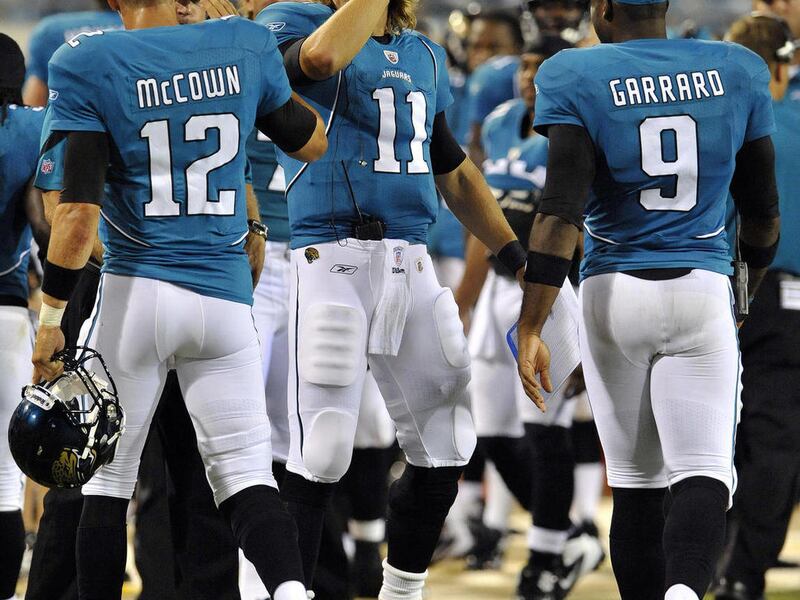 This photo taken Sept. 1, 2011 shows Jacksonville Jaguars quarterback Blaine Gabbert (11) and David Garrard (9) congratulate quarterback Luke McCown (12) after he threw a touchdown pass late in the first half during an NFL preseason football game against