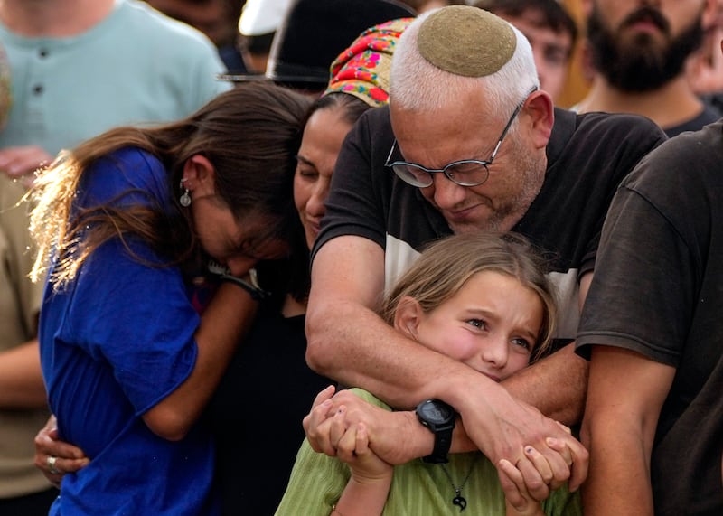 Family members mourn during the funeral of Israeli soldier Shilo Rauchberger in Jerusalem, Israel.