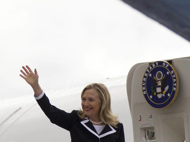 U.S. Secretary of State Hillary Rodham Clinton waves before boarding her plane, Thursday, June 28, 2012, in Riga, Latvia.