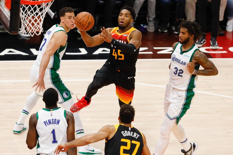 Utah Jazz guard Donovan Mitchell, wearing black, attempts to score past Dallas Mavericks defenders